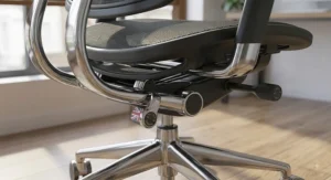 Under-seat view showing the synchro-tilt mechanism and height lever on a mesh ergonomic office chair