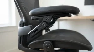 Close-up of the multifunctional armrests on a sleek black task chair with adjustable arms