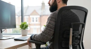 Breathable black mesh-back ergonomic office chair providing full spine support for a tall worker